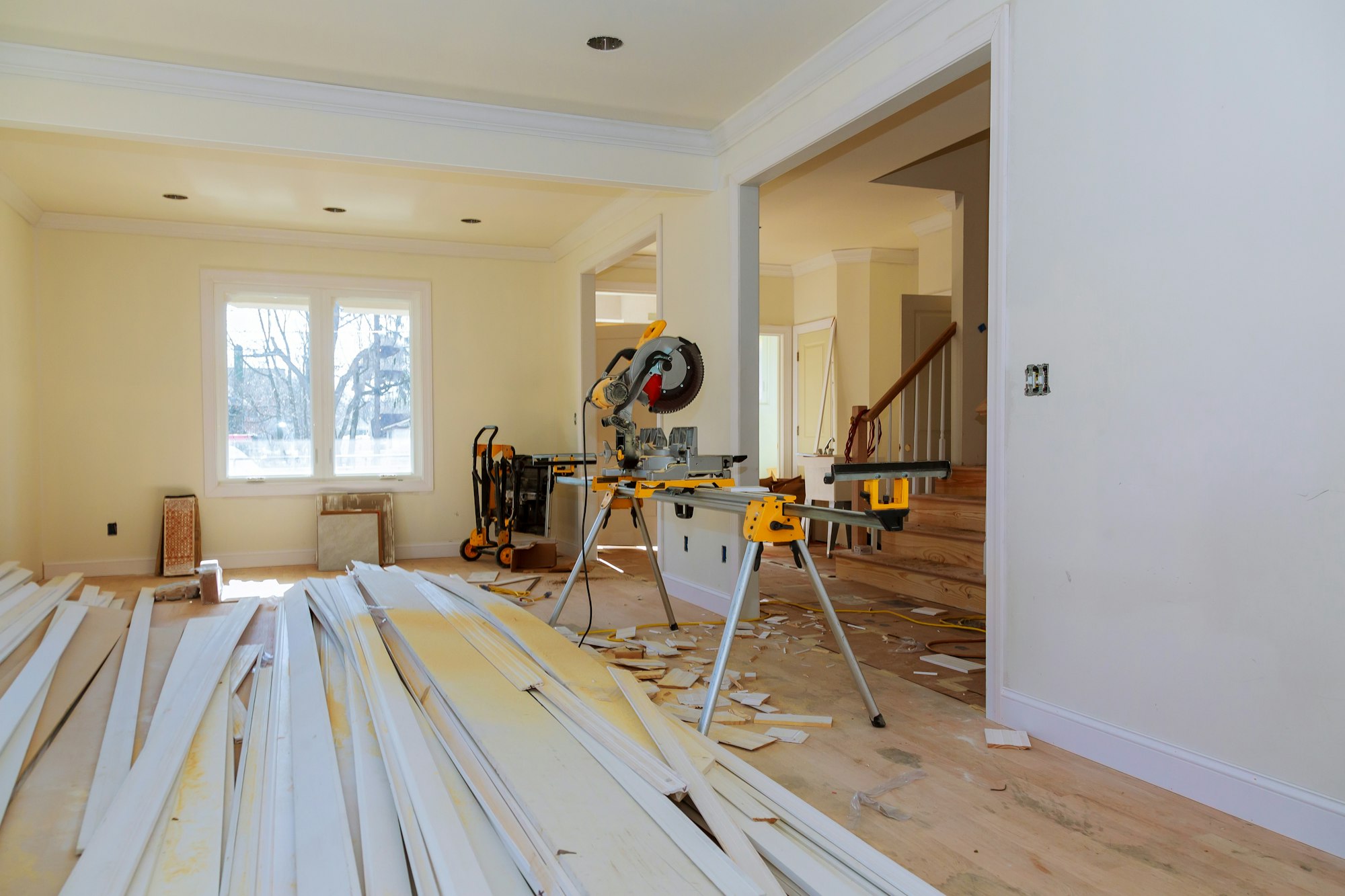 Circular saw cutting wooden trim on with on remodeling home